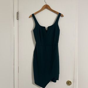 Dark green mini dress with a v-neck asymmetrical hem by Soprano. Size L 10